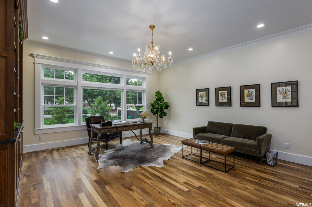 Office area featuring a chandelier, hardwood floors, and crown molding