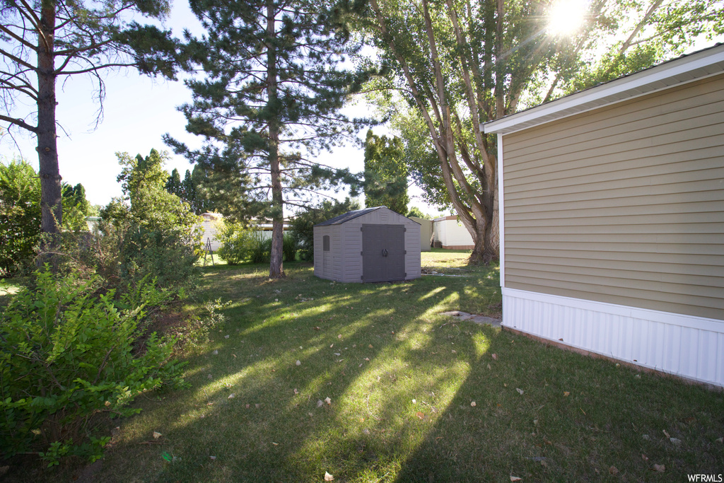 View of yard featuring a storage unit
