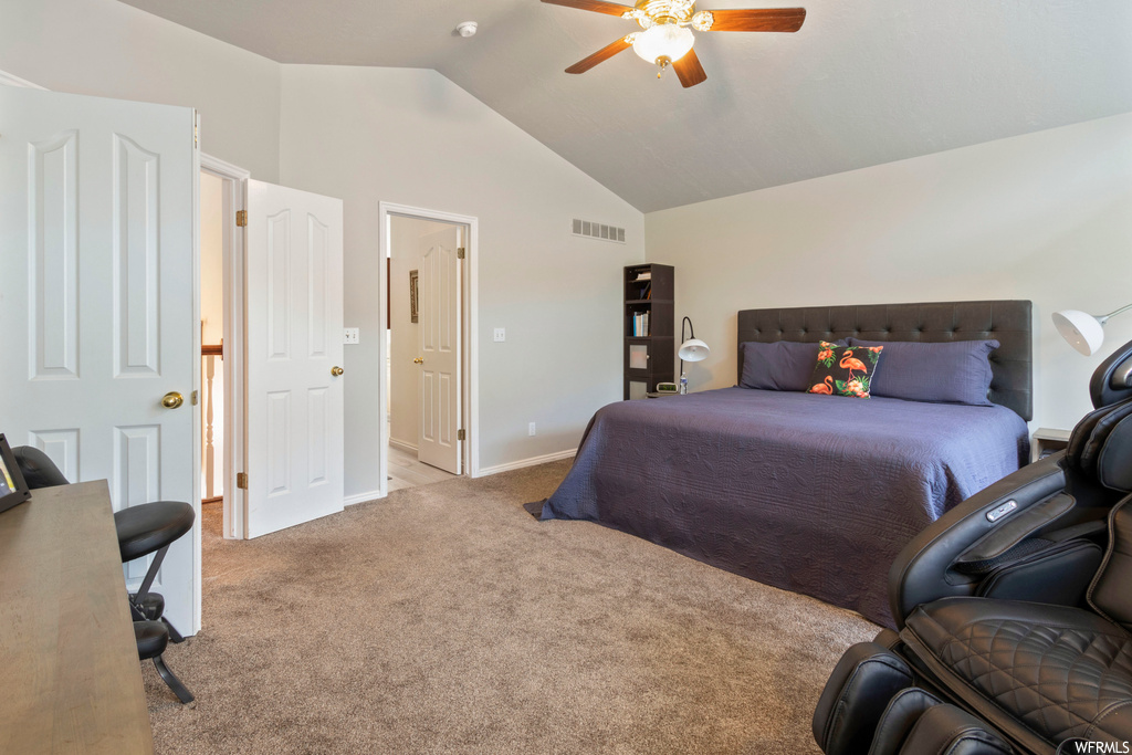 Carpeted bedroom featuring vaulted ceiling, a high ceiling, and ceiling fan