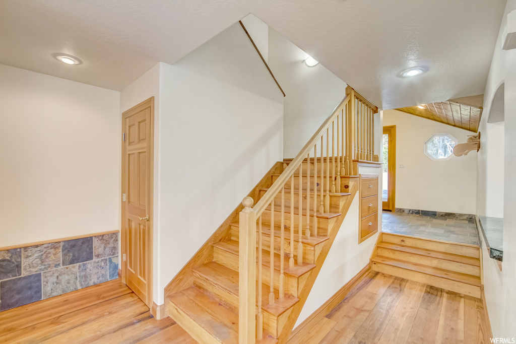Stairs featuring light hardwood floors
