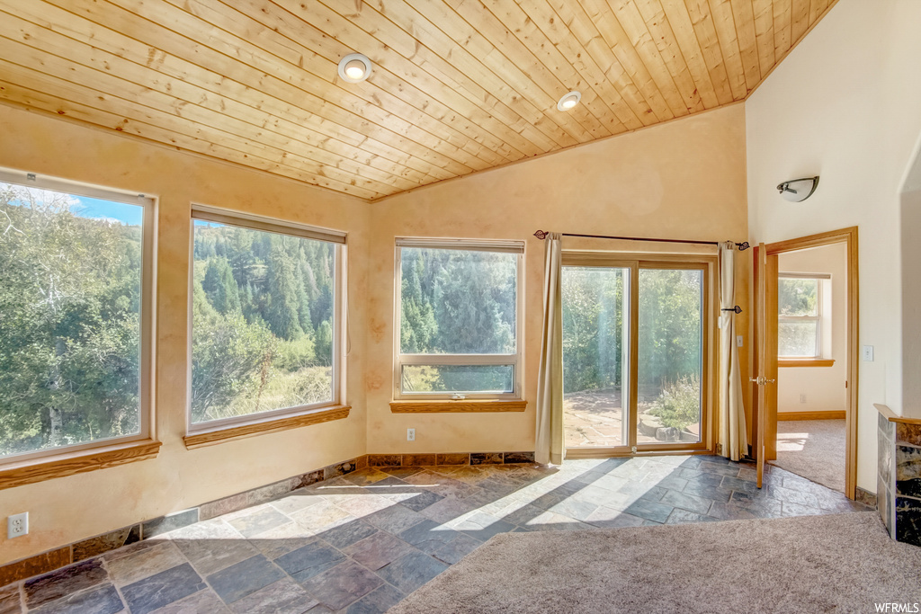 Sunroom featuring wood ceiling and vaulted ceiling