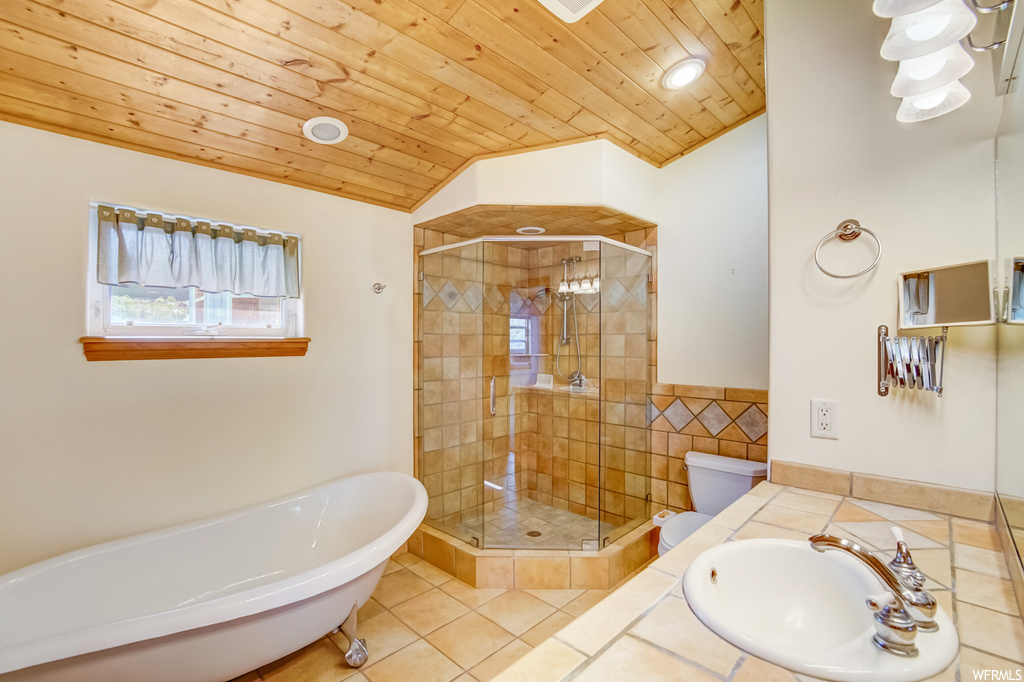 Full bathroom featuring vanity with extensive cabinet space, mirror, vaulted ceiling, independent shower and bath, wood ceiling, and light tile flooring