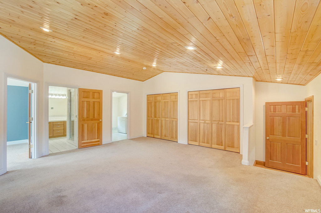 Bedroom with light carpet, wood ceiling, and vaulted ceiling