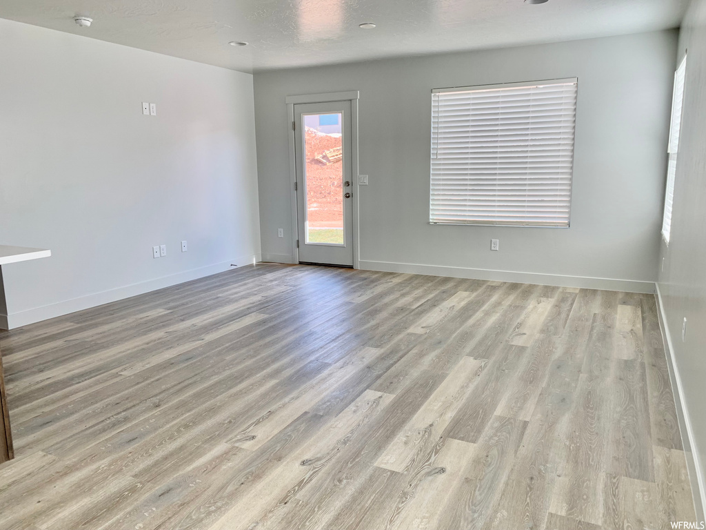Empty room with light hardwood flooring