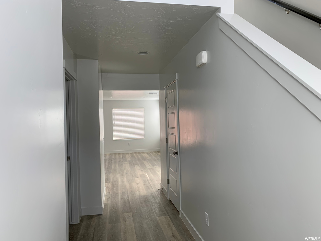 Hallway with light hardwood flooring