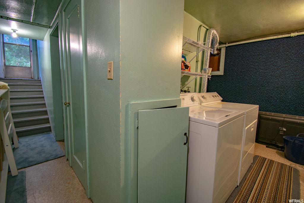 Washroom featuring washing machine and dryer and light colored carpet