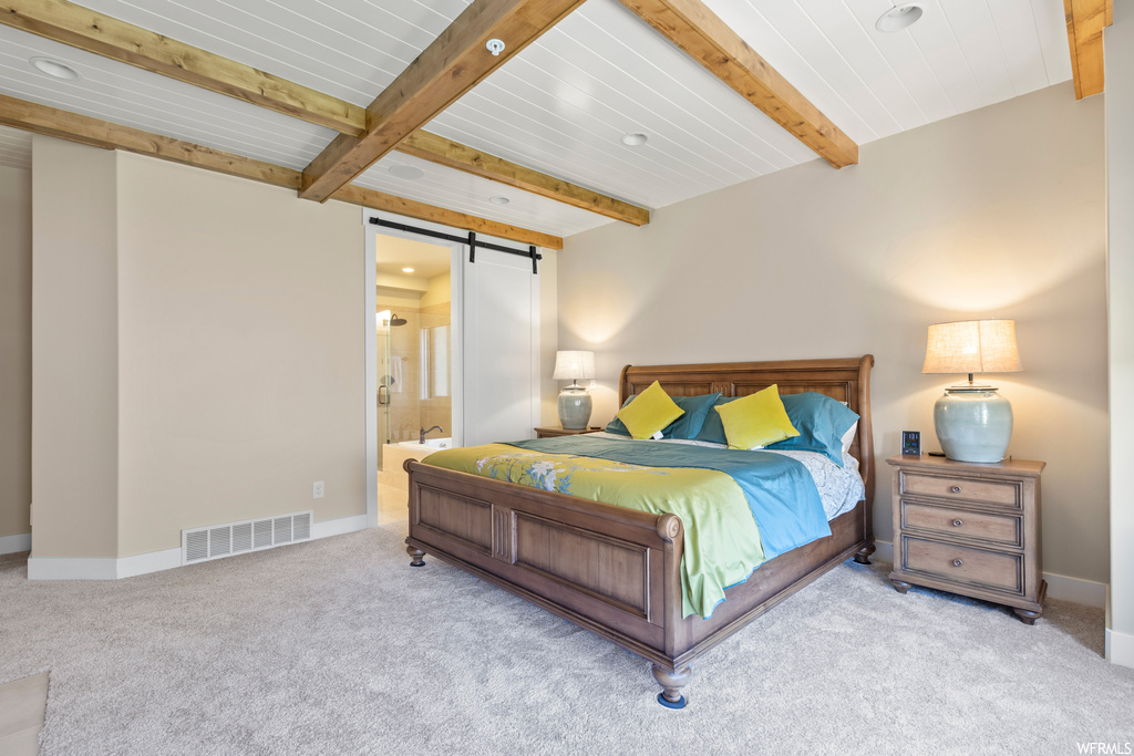 Carpeted bedroom with beam ceiling