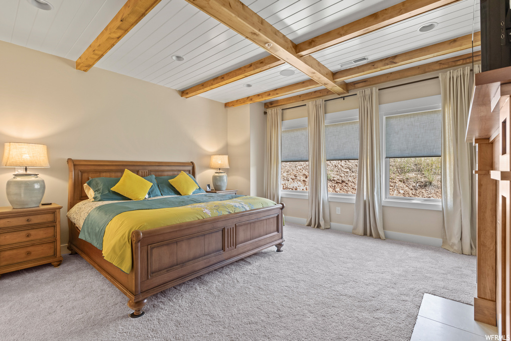 Carpeted bedroom with beamed ceiling