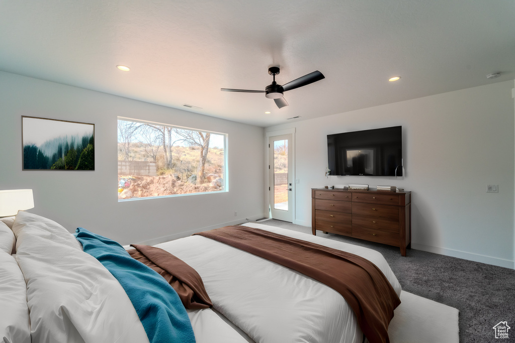 Carpeted bedroom featuring access to exterior and ceiling fan
