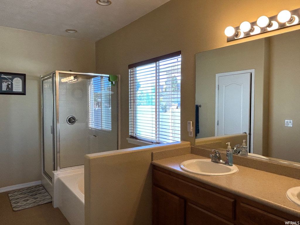 Bathroom with independent shower and bath, oversized vanity, and dual sinks