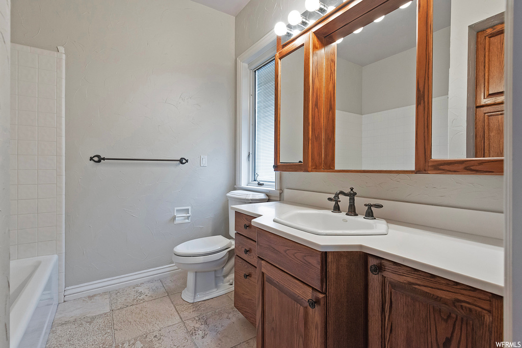 Full bathroom featuring vanity, shower / washtub combination, mirror, and light tile floors
