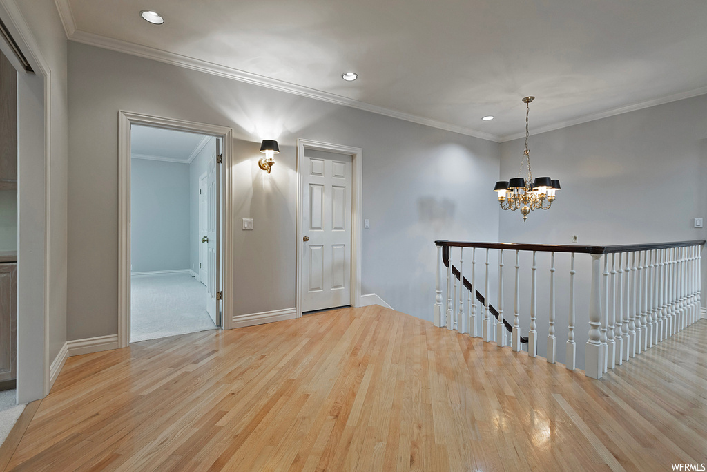 Interior space with crown molding and light hardwood flooring