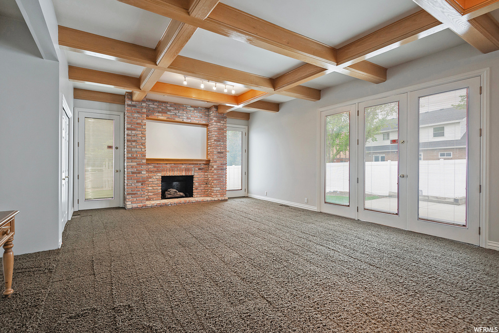 Living room with light carpet, coffered ceiling, and beamed ceiling