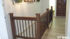 Stairs featuring light hardwood flooring