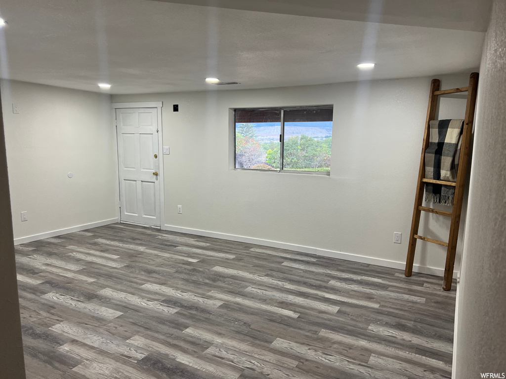 Unfurnished room with hardwood floors