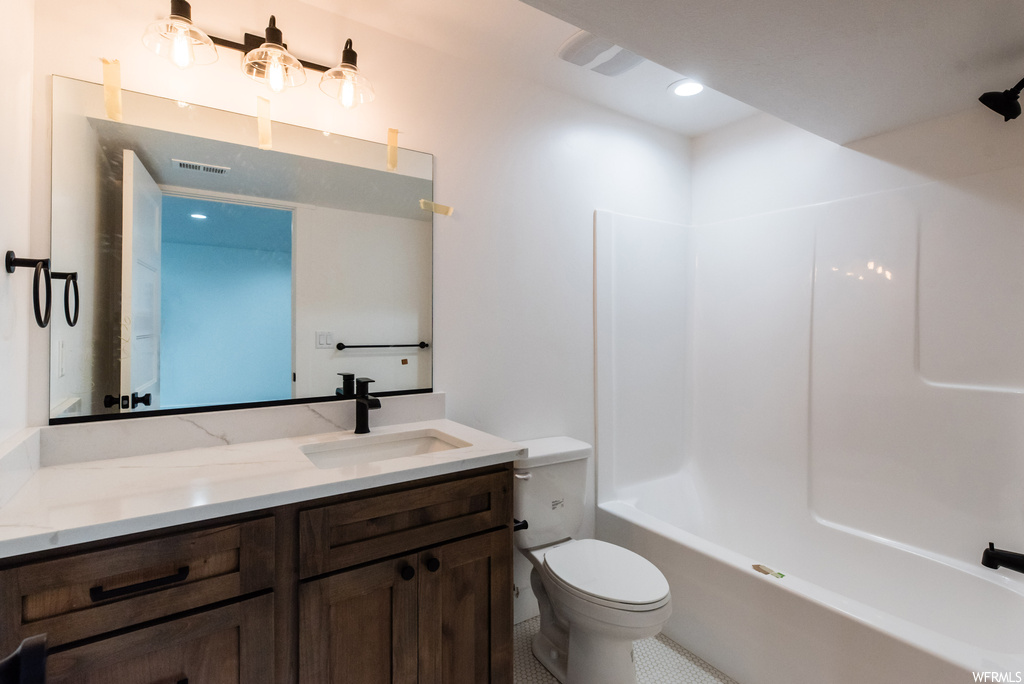 Full bathroom featuring tile flooring, bathtub / shower combination, mirror, and vanity