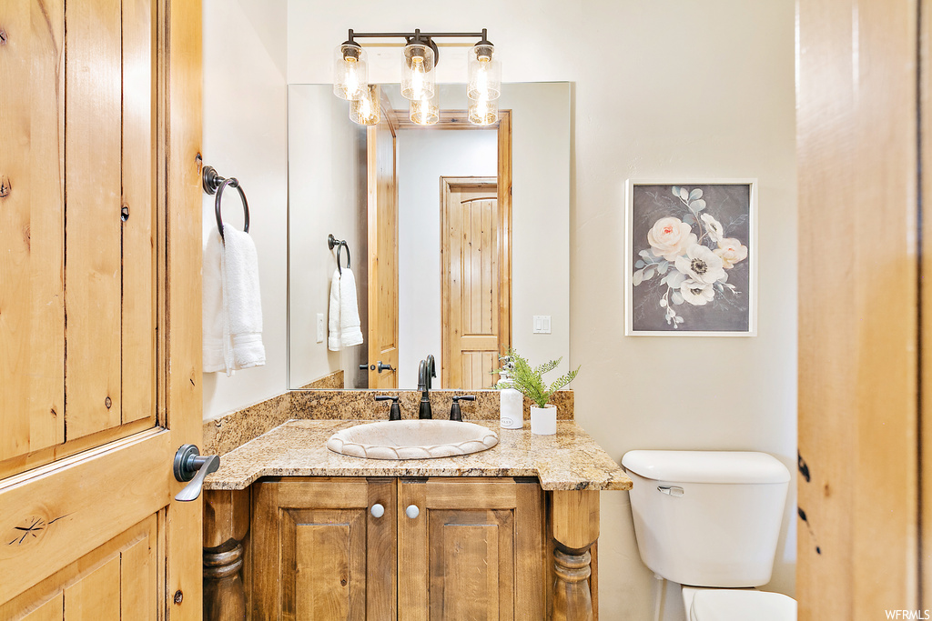 Bathroom with vanity with extensive cabinet space and mirror