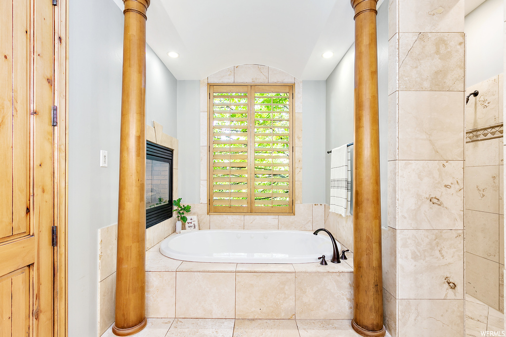 Bathroom with a relaxing tiled bath and vaulted ceiling