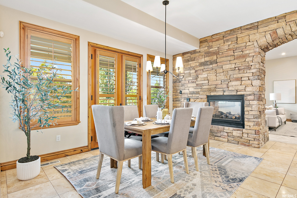 Tiled dining area featuring a fireplace