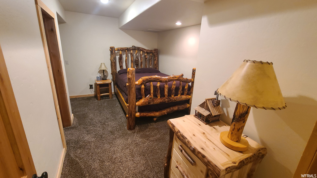 Bedroom featuring dark carpet