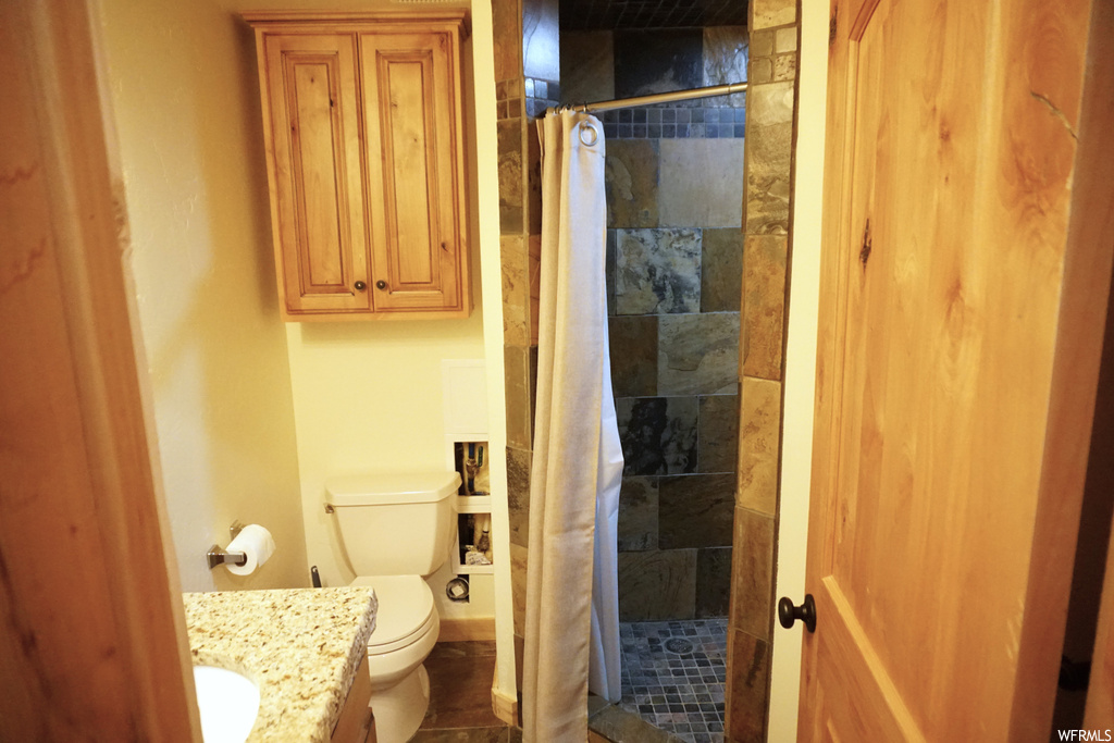 Bathroom featuring tile floors, vanity, and a shower with shower curtain