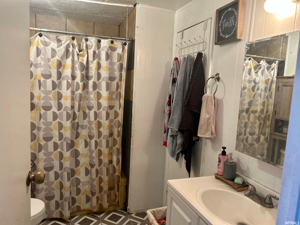 Bathroom with tile floors, vanity, and mirror