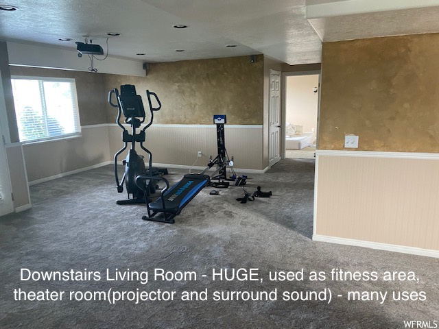 Workout room featuring carpet and a textured ceiling