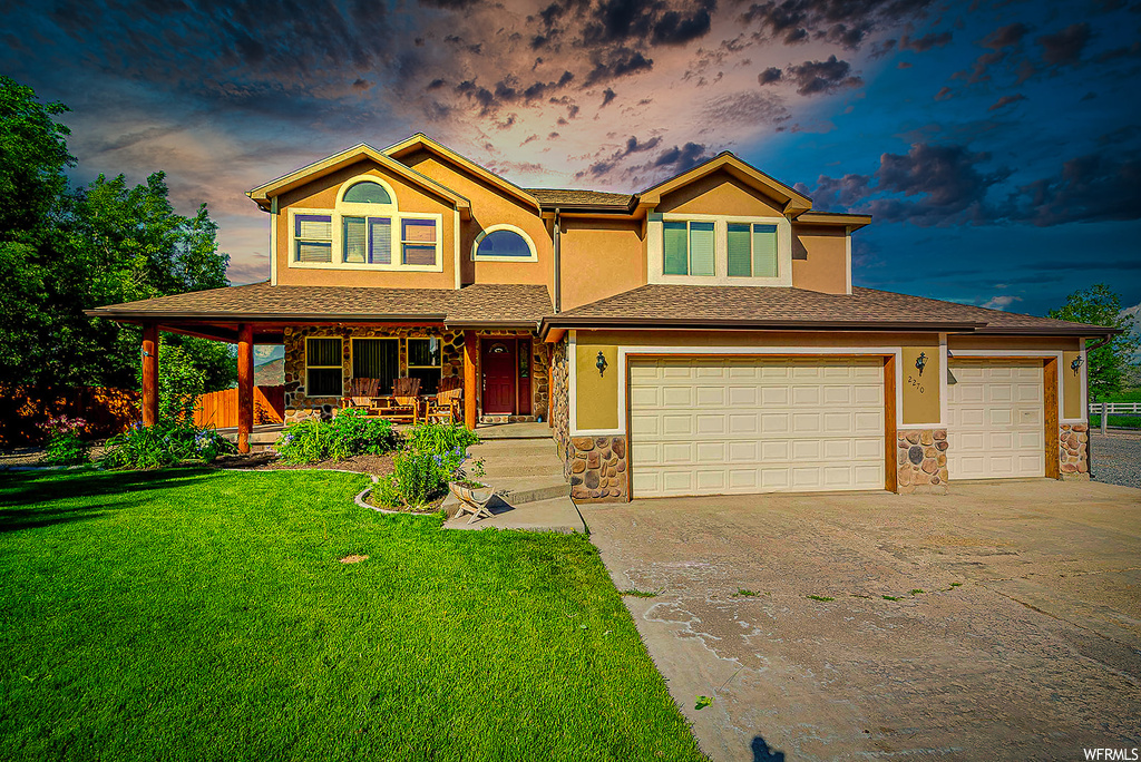 View of front of house featuring a yard and a porch