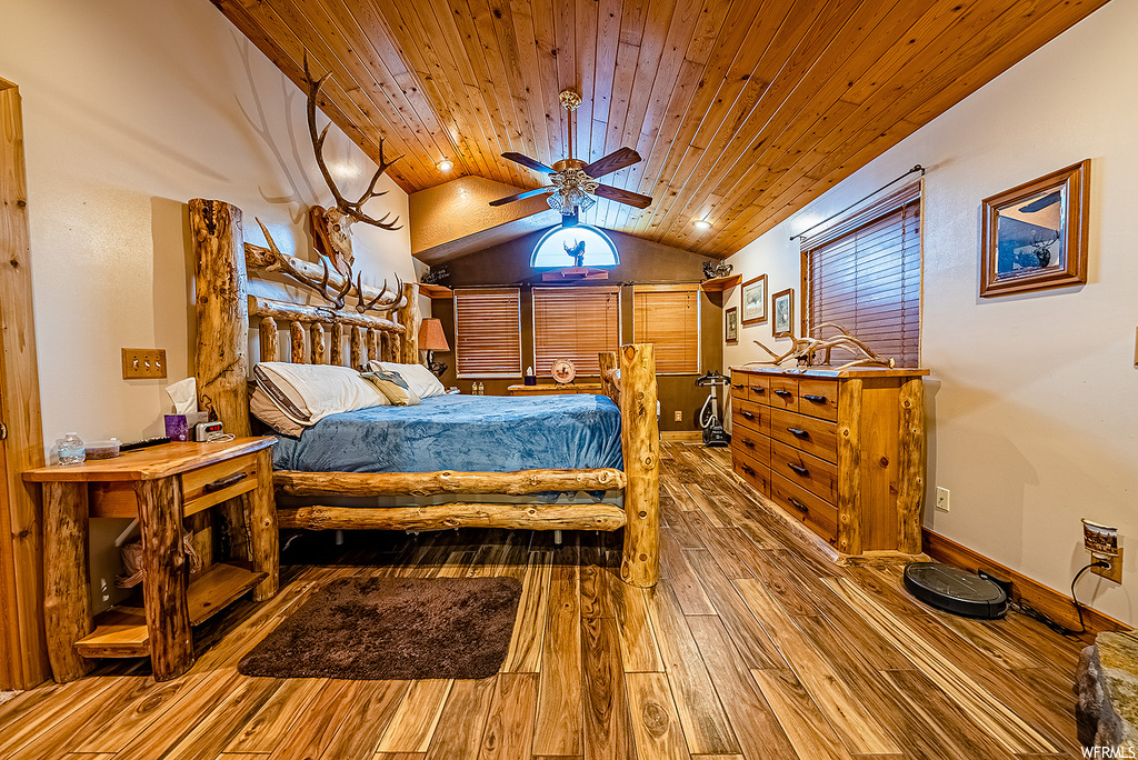 Bedroom with ceiling fan, wooden ceiling, lofted ceiling, and wood-type flooring