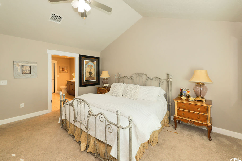 Bedroom featuring light carpet, lofted ceiling, and ceiling fan