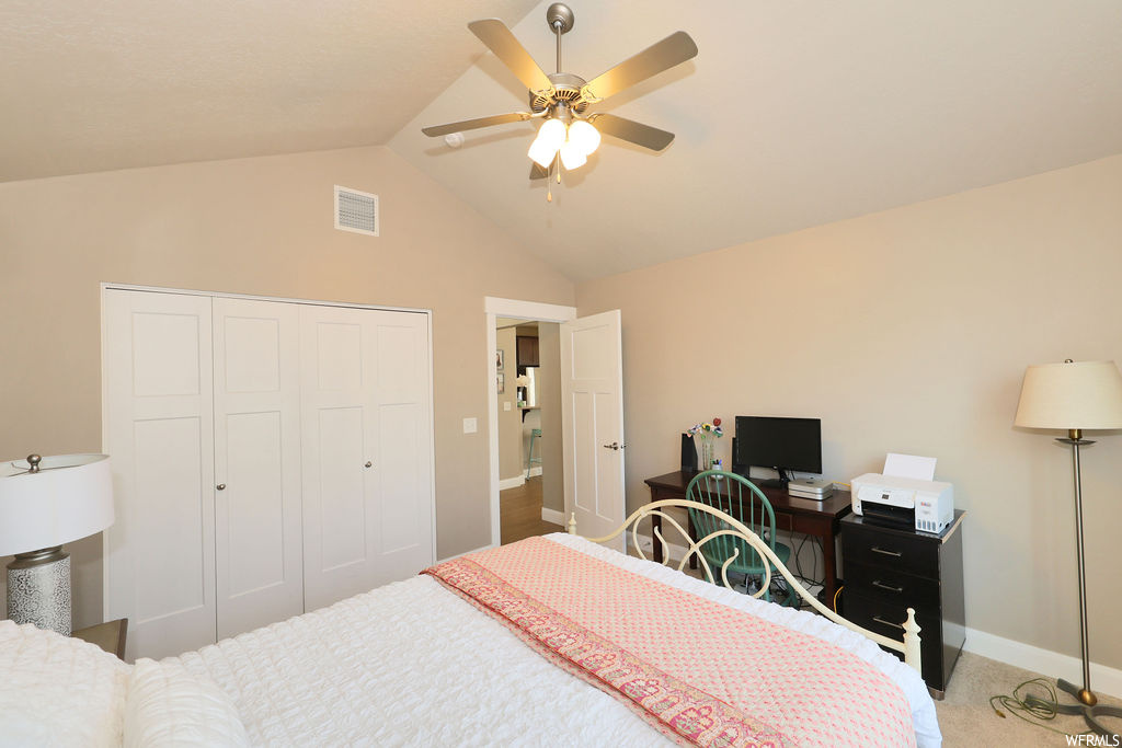 Carpeted bedroom with lofted ceiling