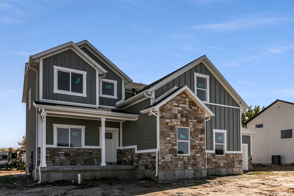Craftsman-style house featuring central AC unit