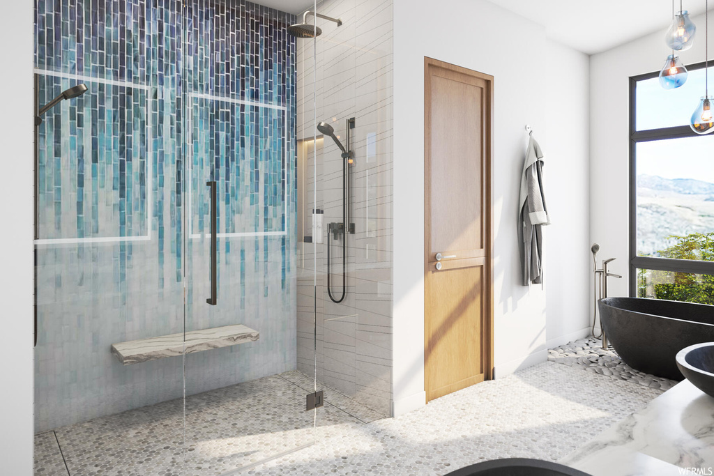 Bathroom featuring separate shower and tub enclosures and a healthy amount of sunlight