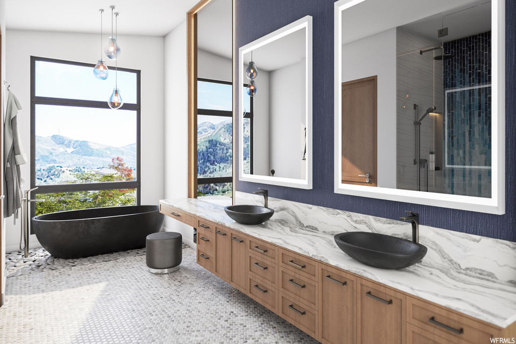 Bathroom featuring double vanity, mirror, a bath to relax in, and vaulted ceiling