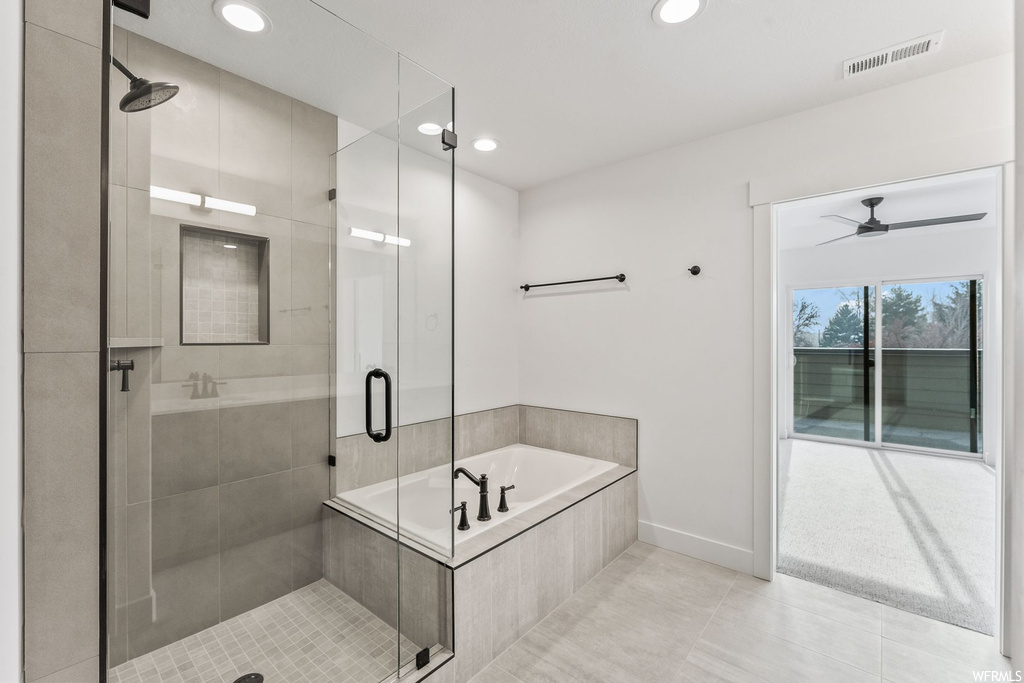 Bathroom featuring ceiling fan, shower with separate bathtub, and tile floors