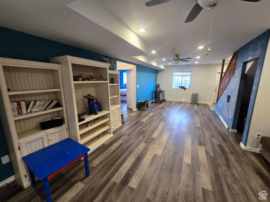 Interior space featuring a textured ceiling and dark hardwood / wood-style flooring