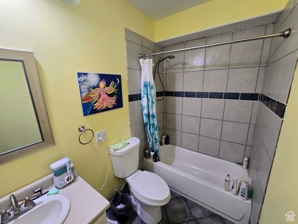 Full bathroom with tile floors, vanity, shower / bath combination with curtain, and toilet