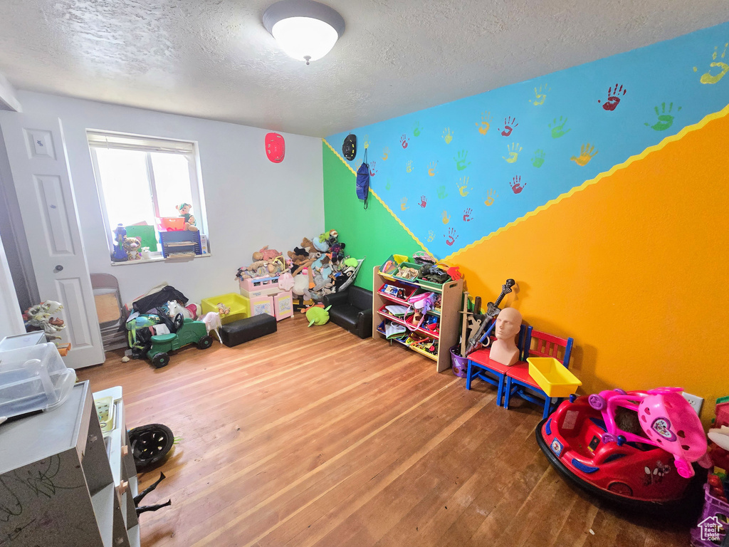 Playroom featuring hardwood / wood-style flooring and a textured ceiling