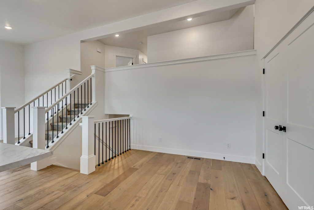 Stairway with light hardwood floors