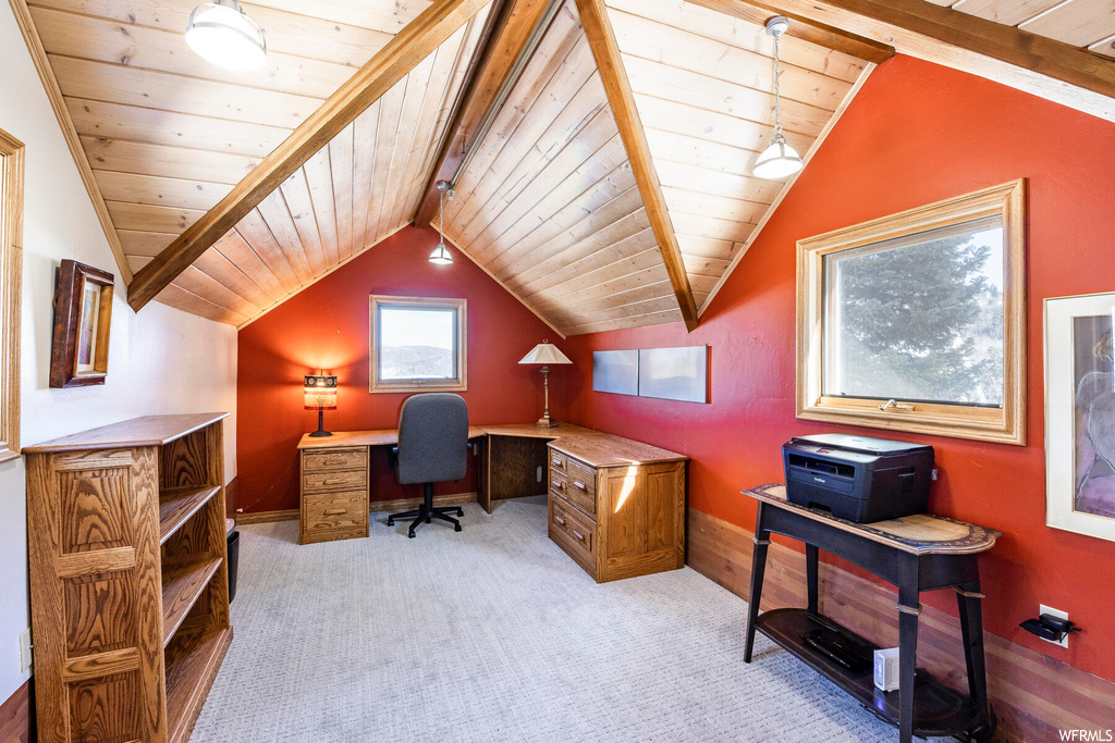 Carpeted home office featuring wood ceiling and lofted ceiling with beams