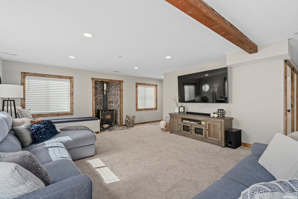 Living room featuring beam ceiling and carpet flooring