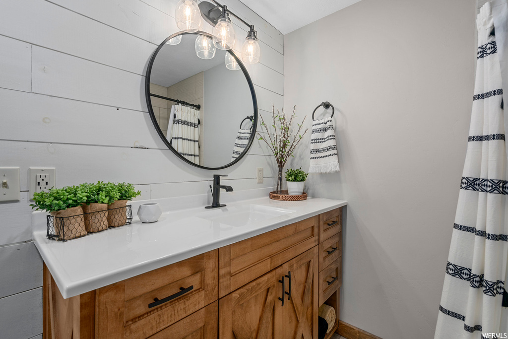 Bathroom with vanity and mirror