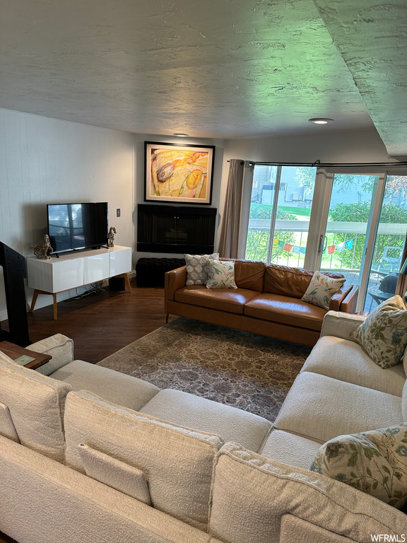 Hardwood floored living room with a textured ceiling
