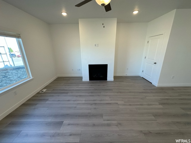 Hardwood floored living room with ceiling fan