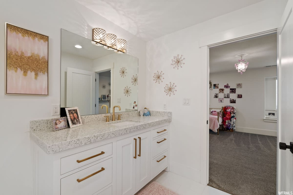 Bathroom with vanity, mirror, and washer and clothes dryer