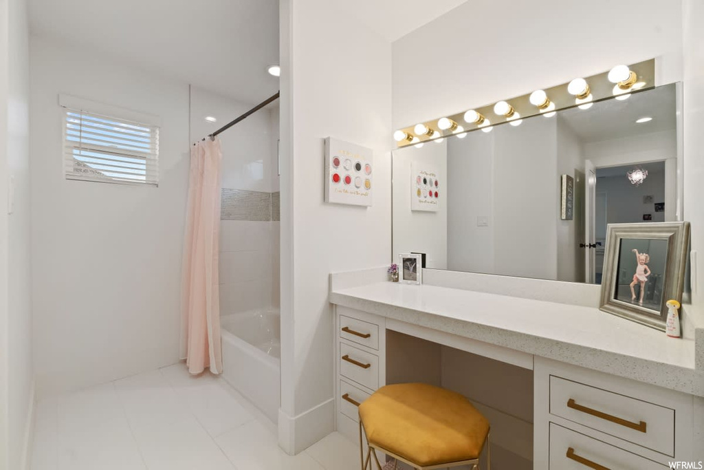 Bathroom with shower / tub combo, light tile flooring, mirror, and vanity