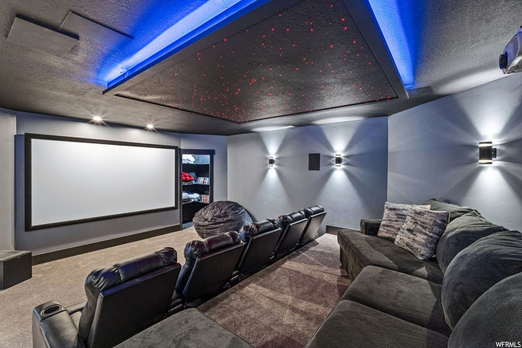Cinema room featuring dark carpet and a textured ceiling