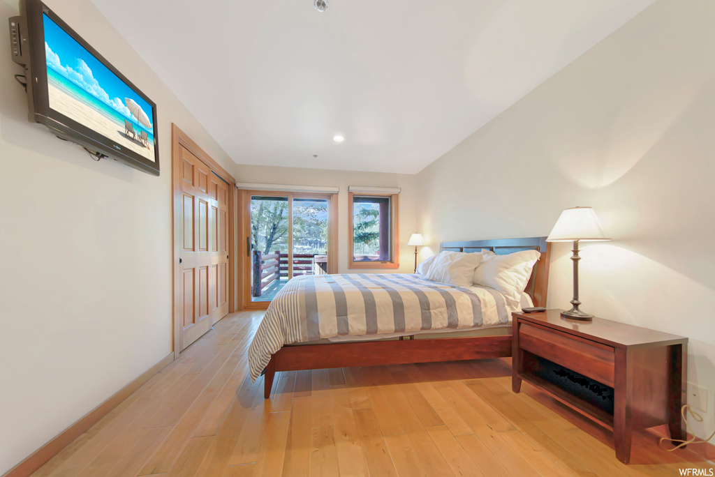 Bedroom with light hardwood / wood-style flooring and access to exterior