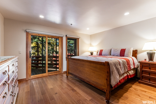 Hardwood floored bedroom featuring access to exterior