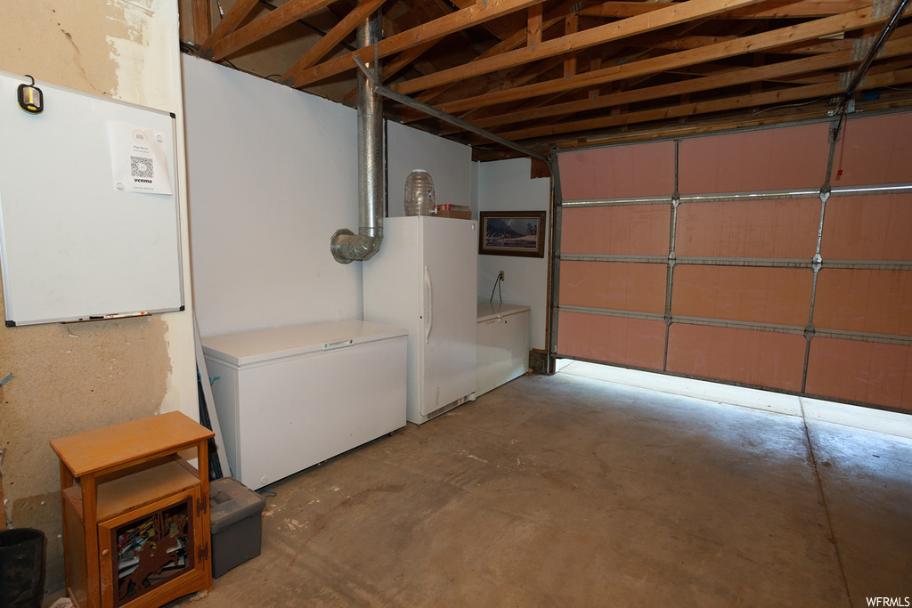 Garage with white refrigerator and fridge